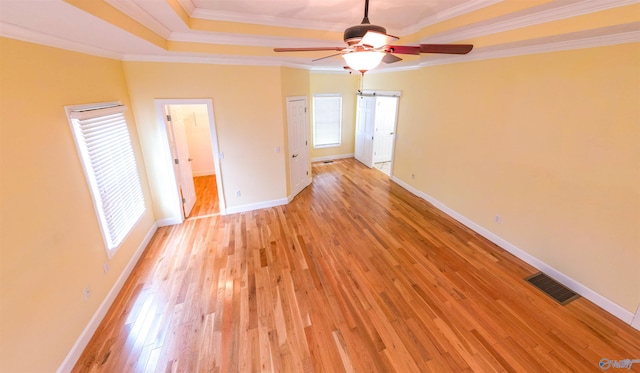 unfurnished bedroom featuring light wood-type flooring, crown molding, and ceiling fan