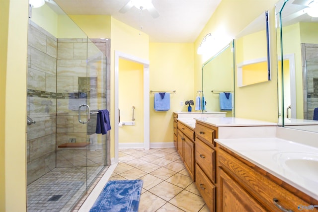 bathroom with ceiling fan, vanity, an enclosed shower, and tile patterned floors