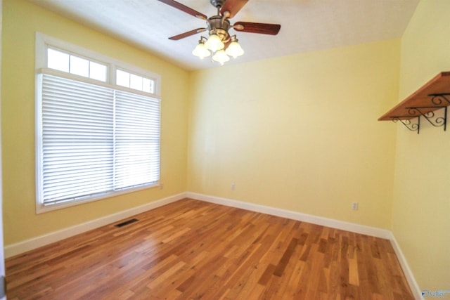 spare room with ceiling fan and hardwood / wood-style flooring