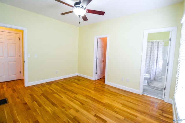 unfurnished bedroom with ensuite bath, light hardwood / wood-style flooring, and ceiling fan