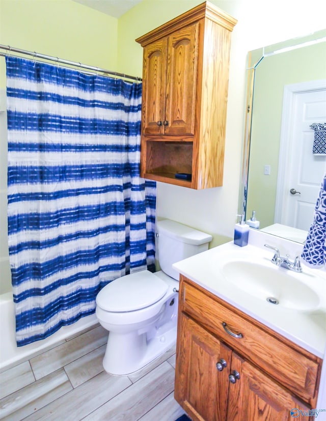 full bathroom with shower / bath combo, vanity, and toilet