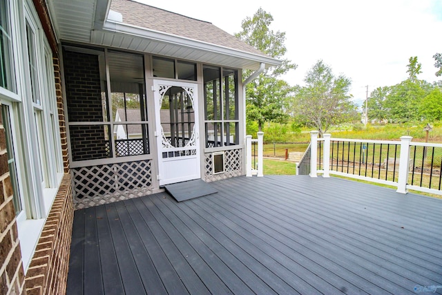 wooden terrace featuring a sunroom