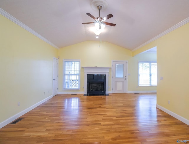 unfurnished living room with ceiling fan, vaulted ceiling, crown molding, and light hardwood / wood-style floors