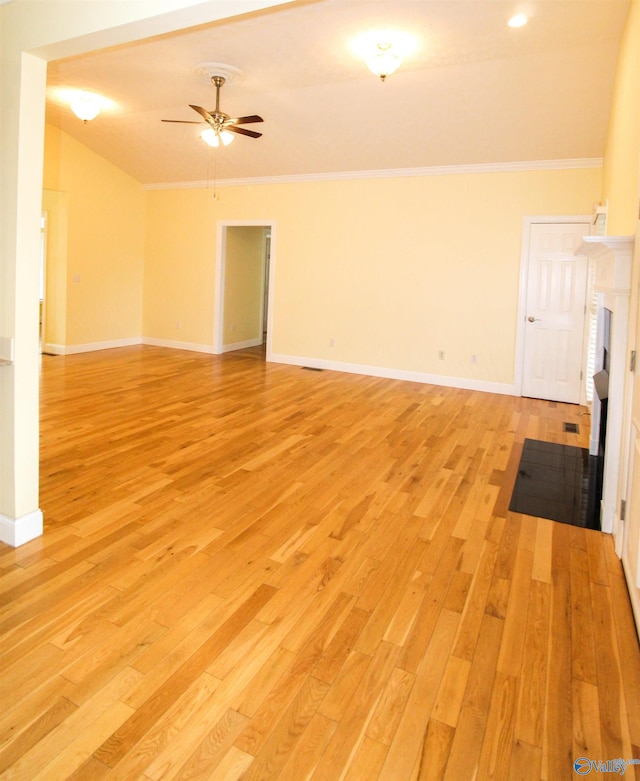 unfurnished living room featuring light wood-type flooring, crown molding, lofted ceiling, and ceiling fan