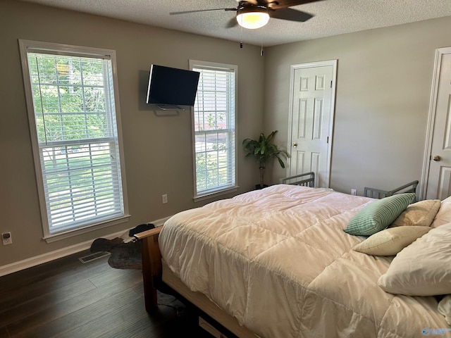 535 10th St NW, Arab, AL 35016 - bedroom with dark wood-style floors, a textured ceiling, baseboards, and ceiling fan