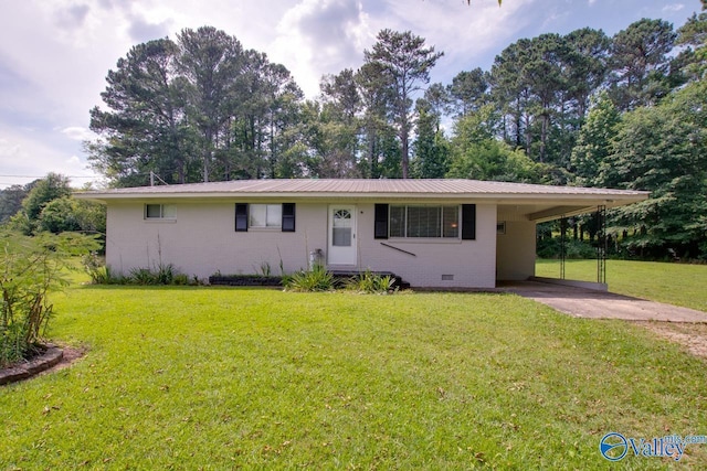 7615 Scottsboro Hwy, Scottsboro, AL 35769 - single story home with a carport, concrete driveway, brick siding, and a front lawn