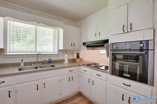 7615 Scottsboro Hwy, Scottsboro, AL 35769 - kitchen with plenty of natural light, under cabinet range hood, white cabinets, electric stovetop, and a sink