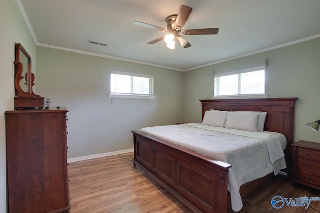 7615 Scottsboro Hwy, Scottsboro, AL 35769 - bedroom with visible vents, light wood-type flooring, ornamental molding, and multiple windows