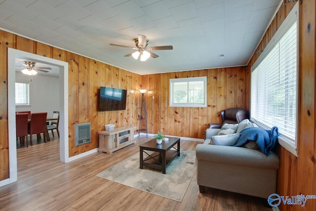 7615 Scottsboro Hwy, Scottsboro, AL 35769 - living room featuring wooden walls, ceiling fan, a healthy amount of sunlight, and baseboards