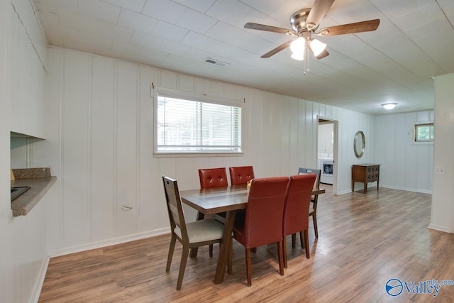 7615 Scottsboro Hwy, Scottsboro, AL 35769 - dining space with visible vents, ceiling fan, light wood finished floors, and baseboards