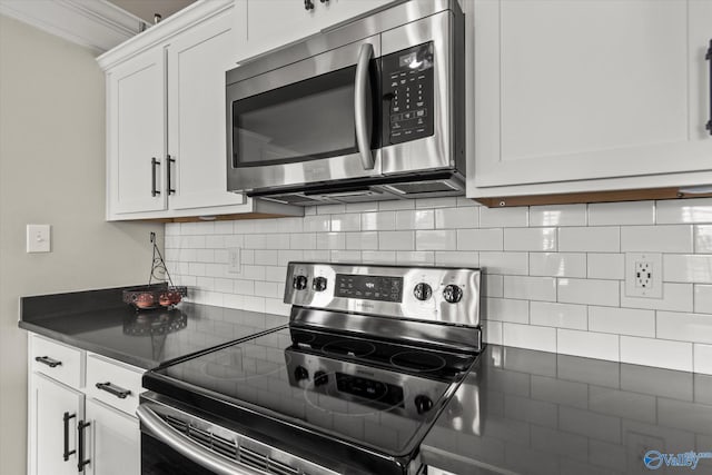 kitchen featuring backsplash, stainless steel appliances, crown molding, and white cabinets