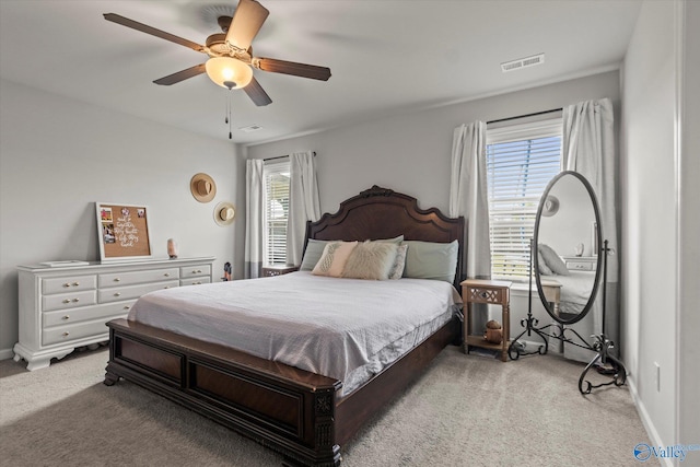 bedroom with light colored carpet and ceiling fan