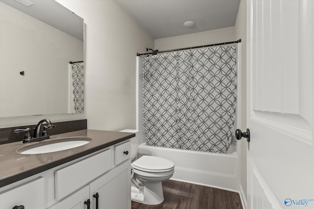 full bathroom with vanity, toilet, hardwood / wood-style floors, and shower / bath combination with curtain