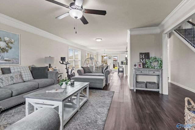 living room with crown molding, dark wood-type flooring, and ceiling fan with notable chandelier