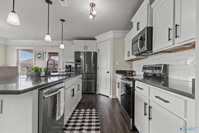 kitchen featuring appliances with stainless steel finishes, tasteful backsplash, sink, dark wood-type flooring, and ornamental molding