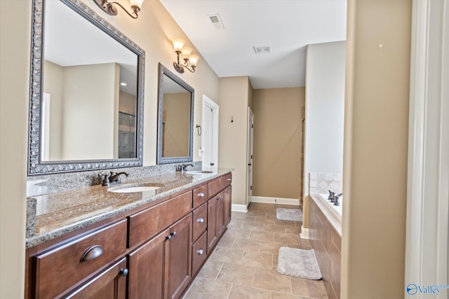 bathroom featuring visible vents, a sink, and a bath