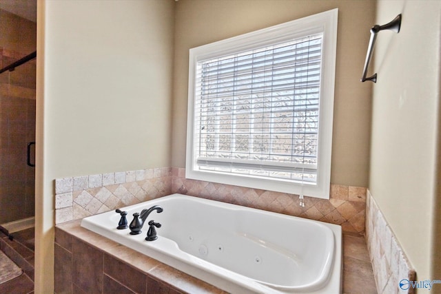 full bathroom with a whirlpool tub, a shower stall, and a wealth of natural light