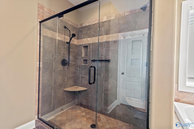 full bathroom featuring a shower stall and a bathtub