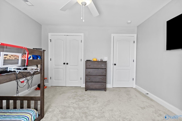 carpeted bedroom with a ceiling fan, a closet, visible vents, and baseboards