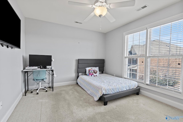 bedroom featuring carpet floors, visible vents, baseboards, and multiple windows