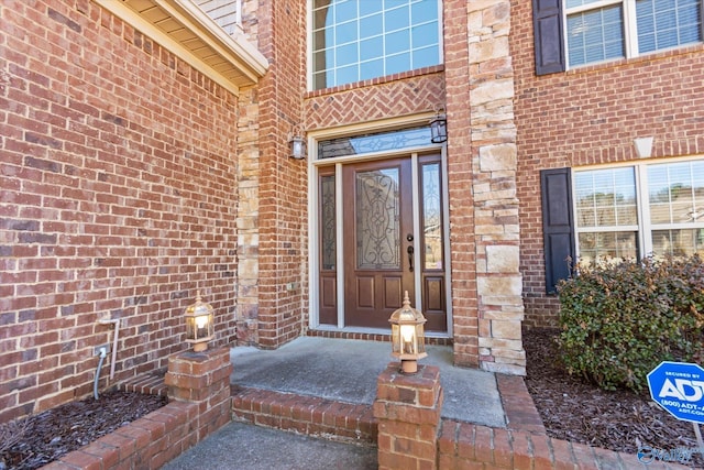 property entrance featuring brick siding