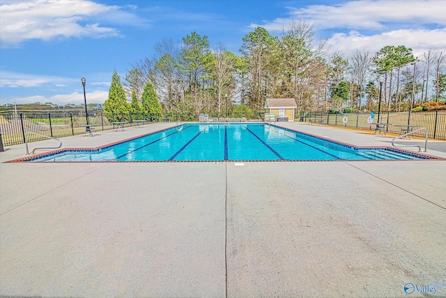 community pool featuring a patio area and fence