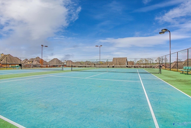 view of sport court featuring fence