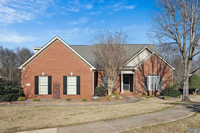 view of front of house with brick siding and a front yard