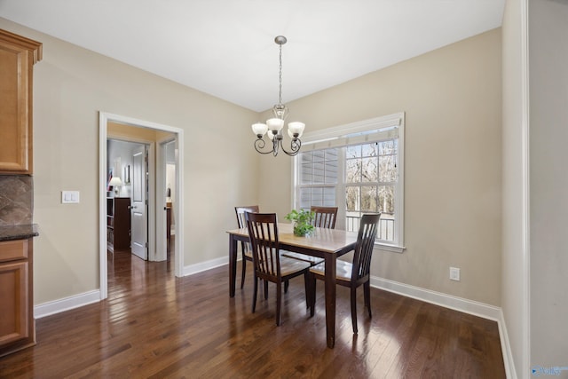 dining room featuring a notable chandelier, baseboards, and dark wood-style flooring