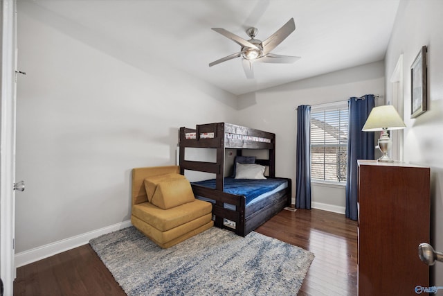 bedroom featuring ceiling fan, baseboards, and dark wood-style flooring