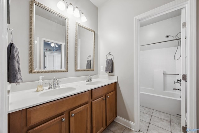 bathroom with a sink, shower / bathtub combination, double vanity, and tile patterned floors