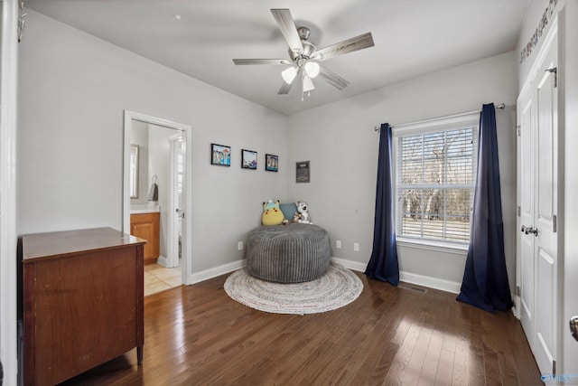 sitting room featuring ceiling fan, baseboards, and hardwood / wood-style floors