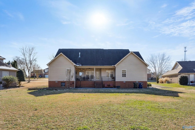 rear view of house with a lawn and a porch