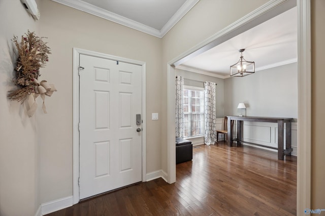 entryway with a chandelier, baseboards, wood finished floors, and crown molding