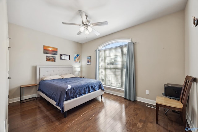 bedroom with ceiling fan, visible vents, baseboards, and hardwood / wood-style floors