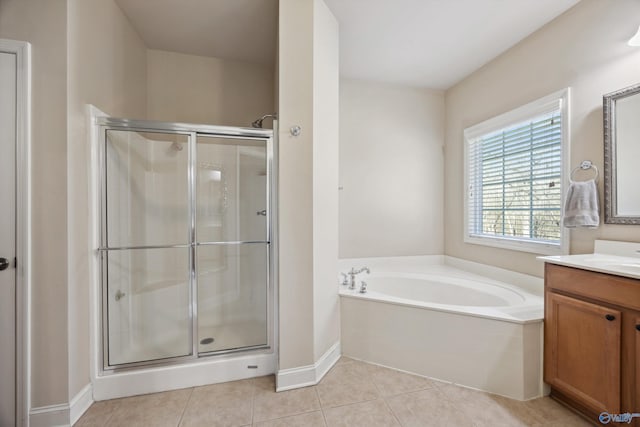 full bathroom with vanity, baseboards, a stall shower, tile patterned flooring, and a garden tub