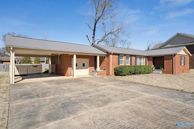 ranch-style home featuring brick siding, an attached garage, driveway, and fence