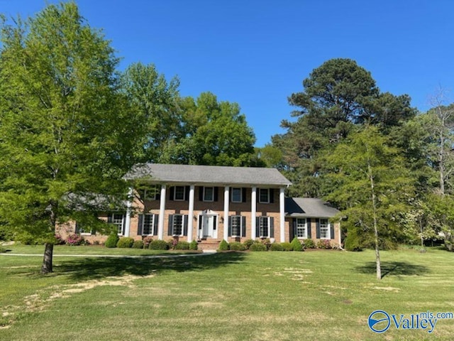greek revival inspired property with a front yard