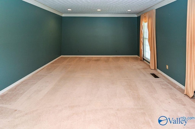 carpeted spare room featuring baseboards, ornamental molding, visible vents, and recessed lighting