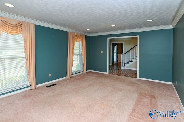 carpeted spare room with baseboards, visible vents, recessed lighting, stairs, and ornamental molding