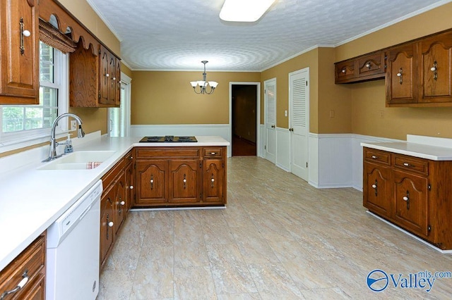 kitchen with white dishwasher, a sink, an inviting chandelier, light countertops, and a peninsula