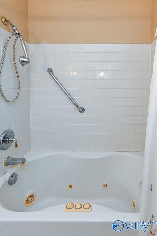full bath with a combined bath / shower with jetted tub