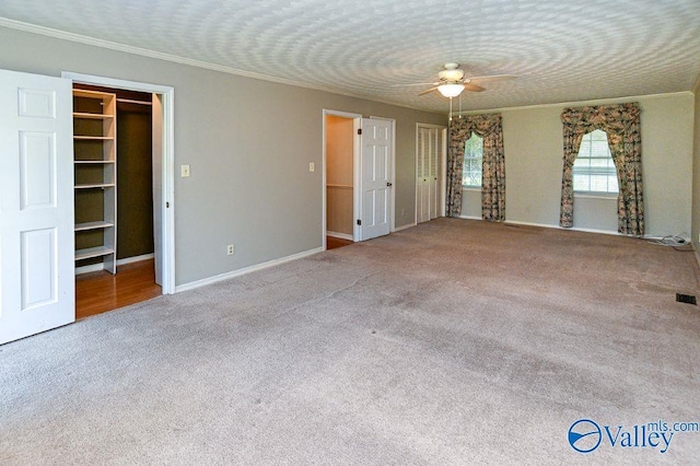 unfurnished bedroom featuring carpet, a closet, baseboards, and ornamental molding