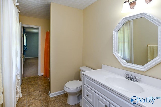 full bath featuring tile patterned flooring, toilet, vanity, and baseboards
