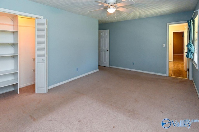 unfurnished bedroom featuring ceiling fan, carpet floors, and baseboards