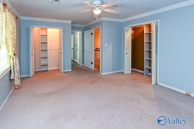 unfurnished bedroom with ceiling fan, carpet floors, and baseboards