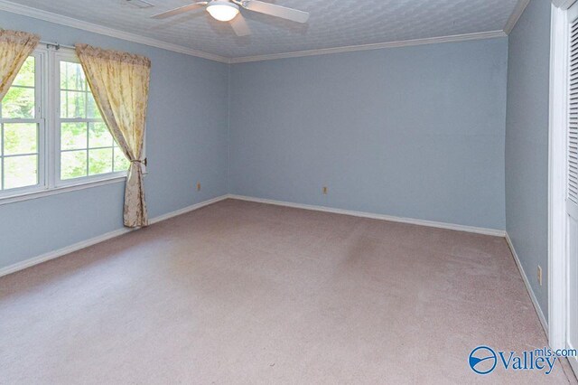 spare room with carpet floors, a ceiling fan, and baseboards