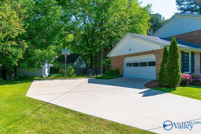 view of front of home featuring concrete driveway, a front lawn, an attached garage, fence, and brick siding