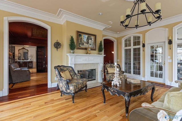 interior space with light hardwood / wood-style flooring, crown molding, and a premium fireplace