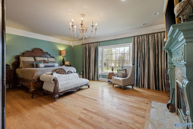 bedroom with light hardwood / wood-style flooring, crown molding, and a notable chandelier